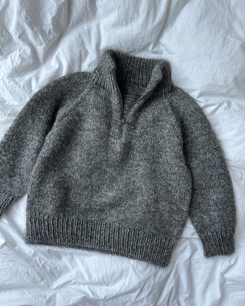 Grå Zipper Sweater Junior på dyne