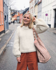Kvinde iført hvid Holiday Sweater 