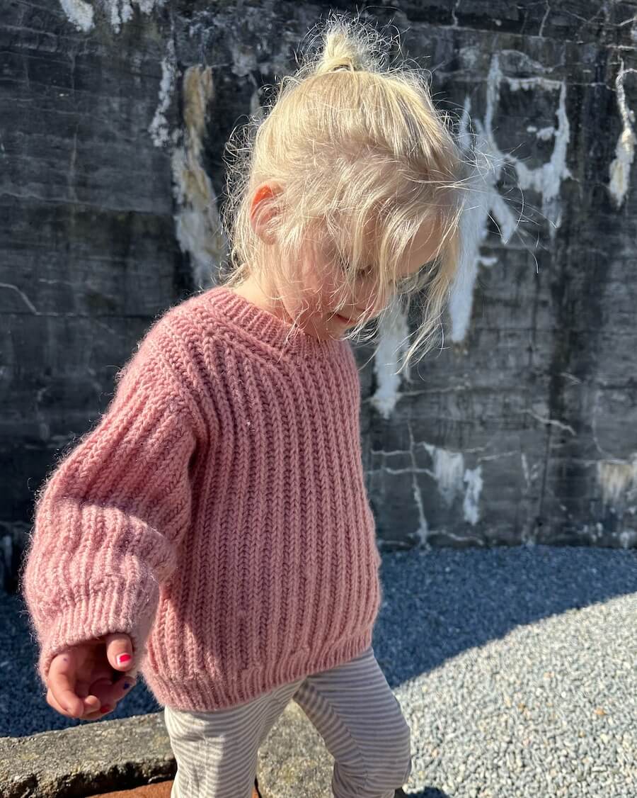 Pige iført lyserød September Sweater Junior